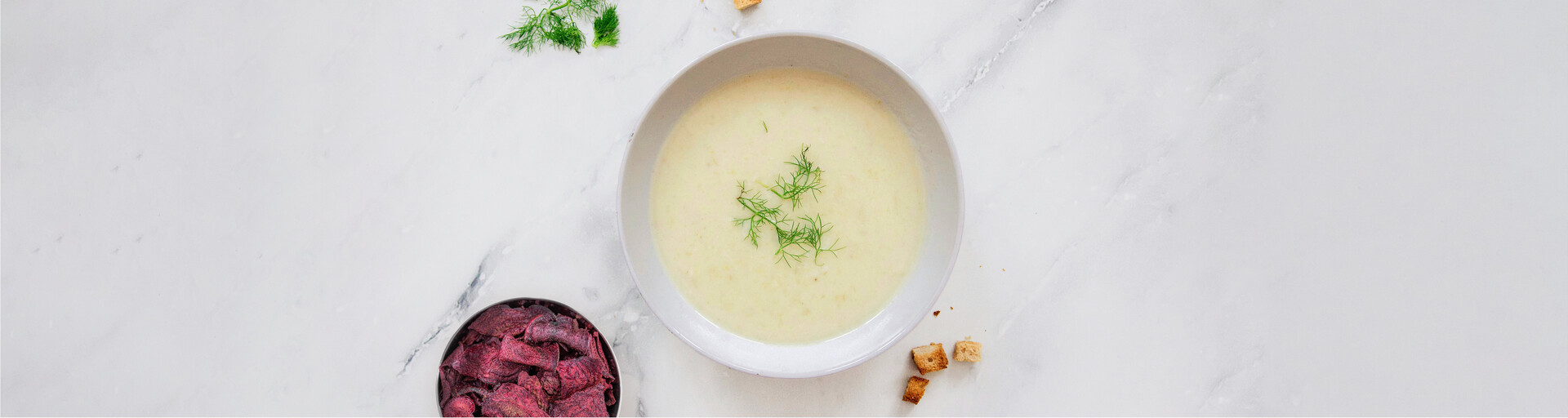 Krensuppe neben einer Schüssel Rote-Rübe-Chips zum Nachkochen - die perfekte Gemüsesuppe für Frühling und Winter. | © Land schafft Leben